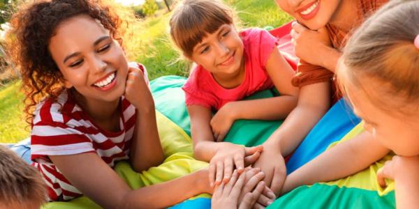 People in a hand-stack gesture showing unity